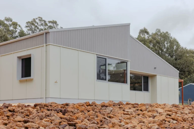 Exterior of the Indianic Homes Woodbridge house with a skillion roof and light cladding in a bush setting