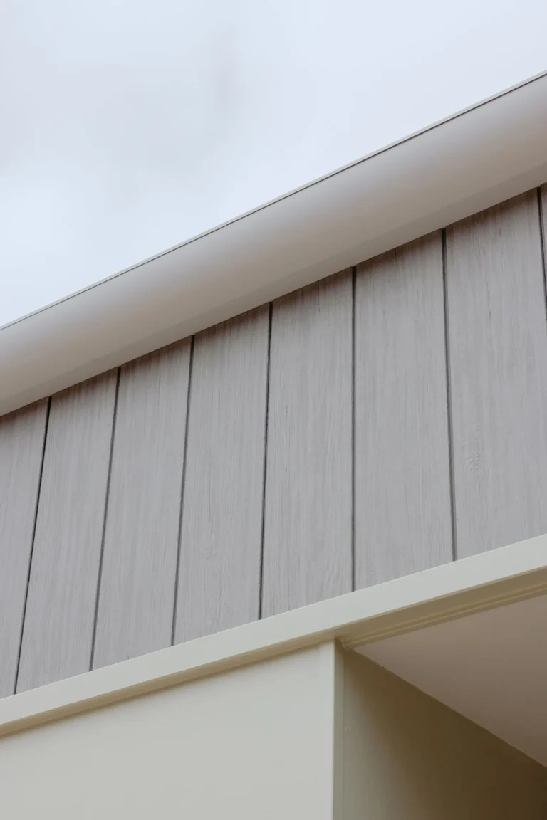 Detail of the eave and timber-look vertical cladding under the roofline