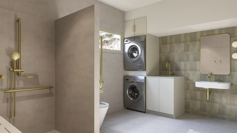 Accessible bathroom and laundry of Kyle Andrews Foundation cabin featuring brushed brass fixtures and earthy sage zellige tiles