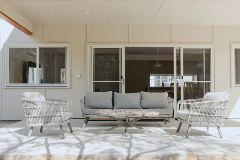 Alfresco lounge setting with sliding doors opening to the open-plan kitchen and dining area
