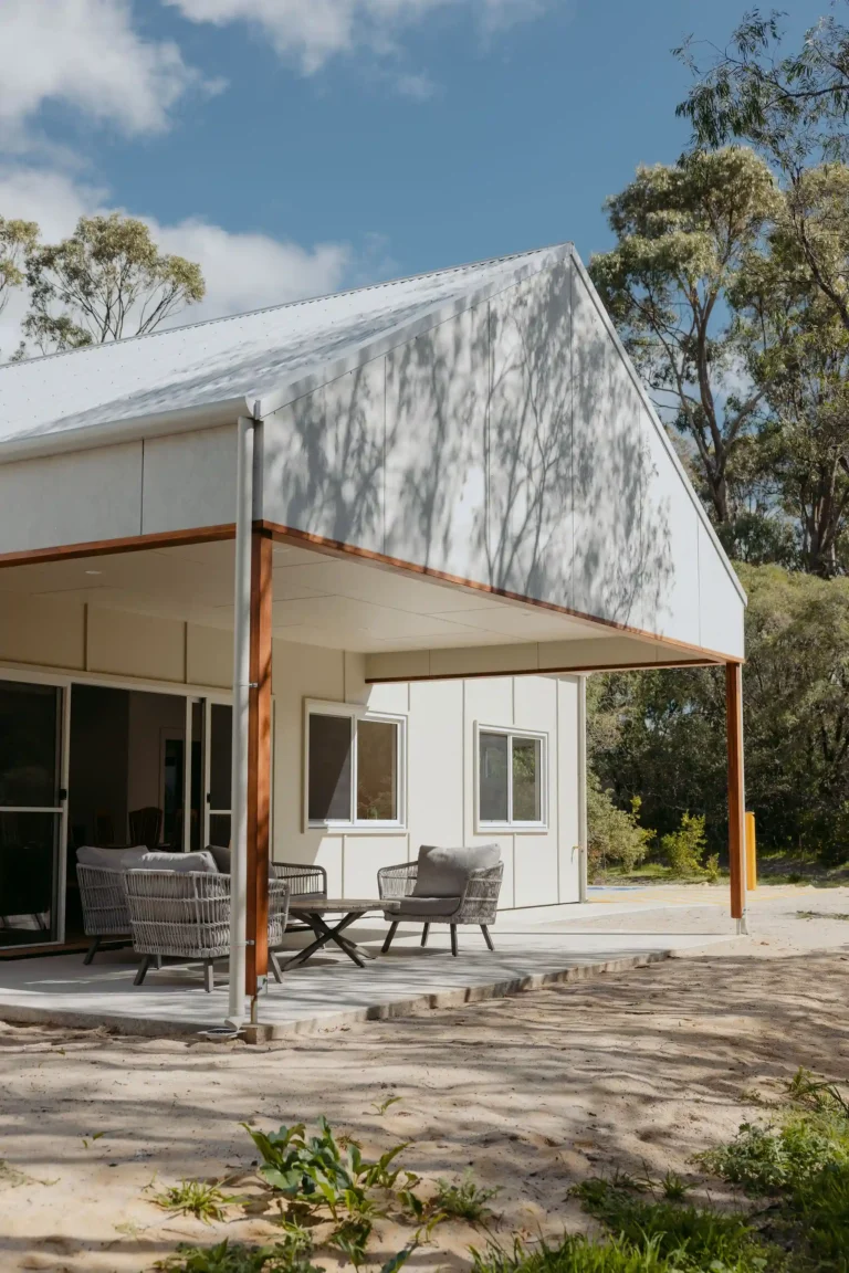 Gable end with timber-beamed alfresco in dappled shade from surrounding gum trees